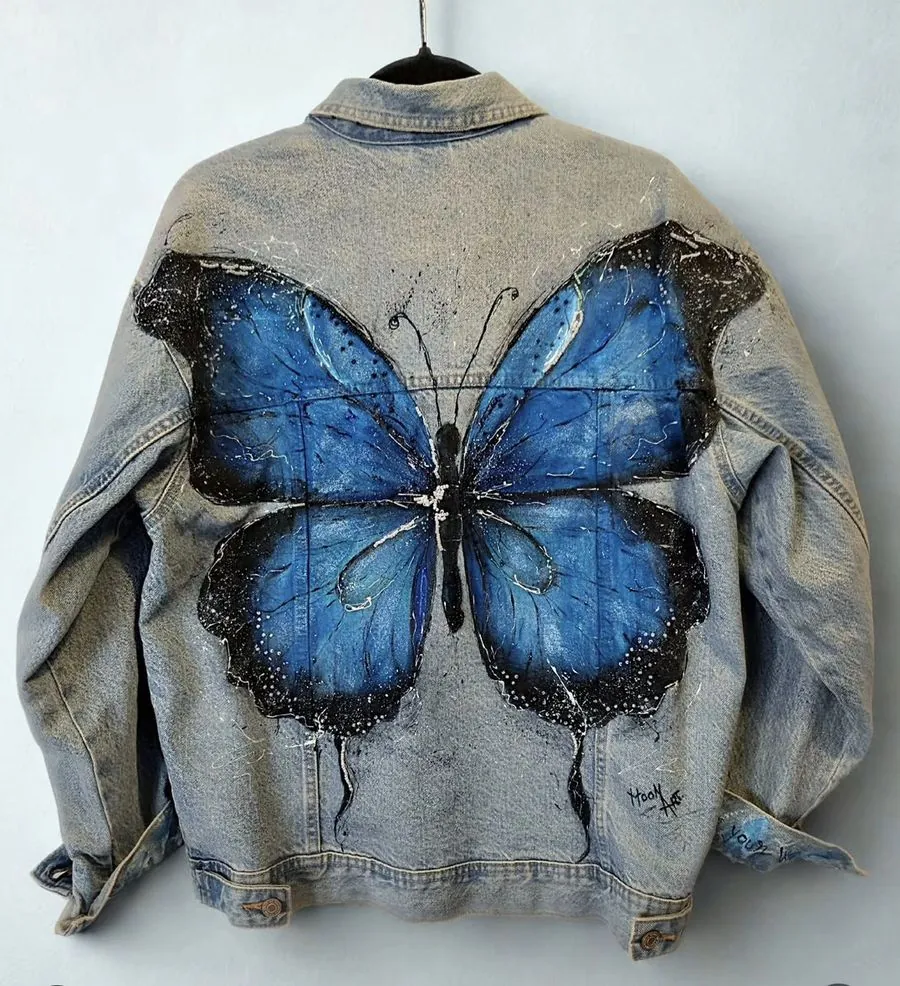 Hand-painted denim jacket with a blue butterfly